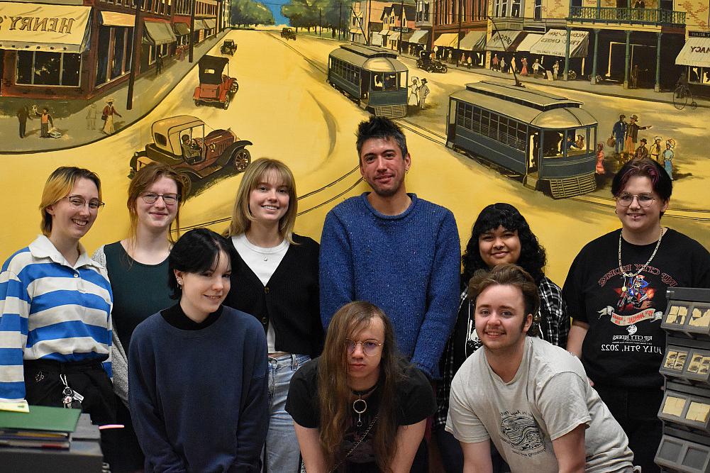 Prof. Michael Dango with Students at the Beloit Historical Society in front of a mural in the library