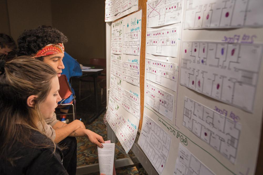 Students weigh their room options from floor plans posted in Pearsons Hall during the room lotter...